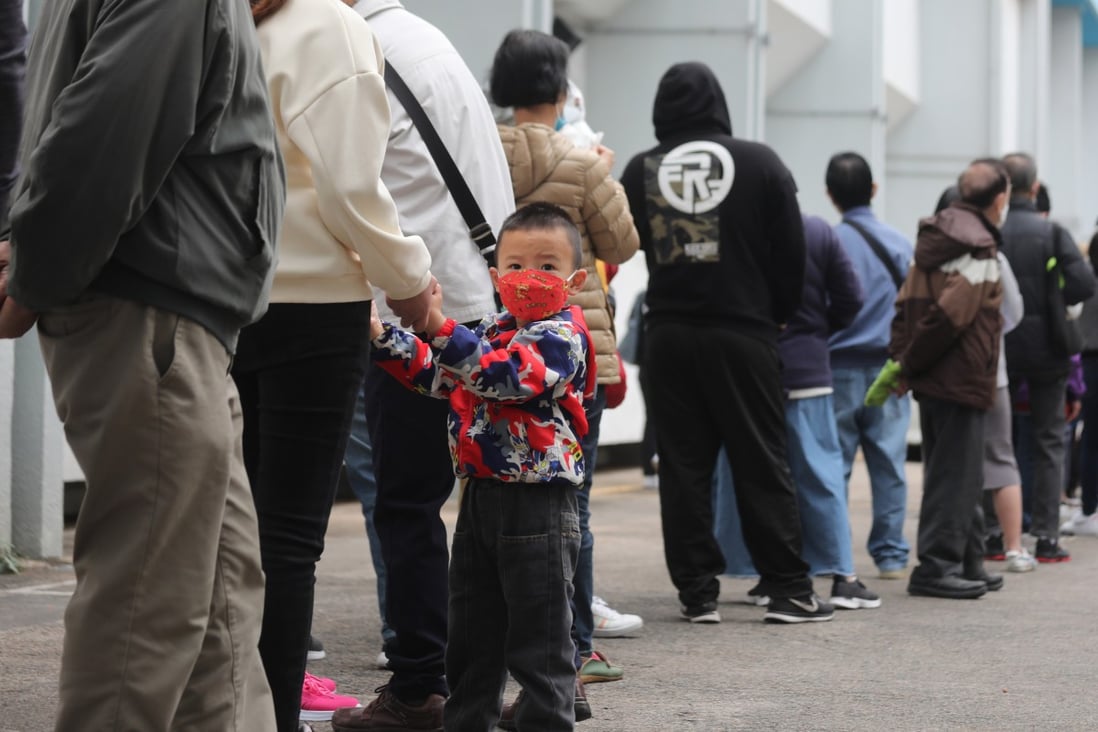 A three-year-old queues for his first Covid-19 vaccine at Yuen Wo Road Sports Centre in Sha Tin. Photo: Xiaomei Chen
