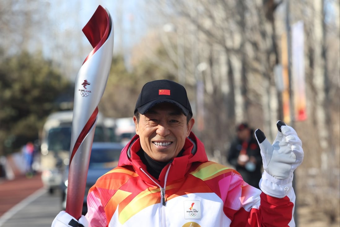 Zhang Yimou runs with the Olympic torch in Beijing. Photo: Xinhua