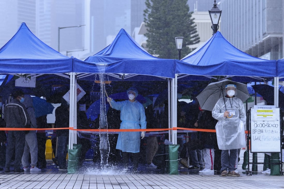 It’s a cold and wet wait for residents lining up for Covid-19 tests in Central, Hong Kong. Photo: Nora Tam