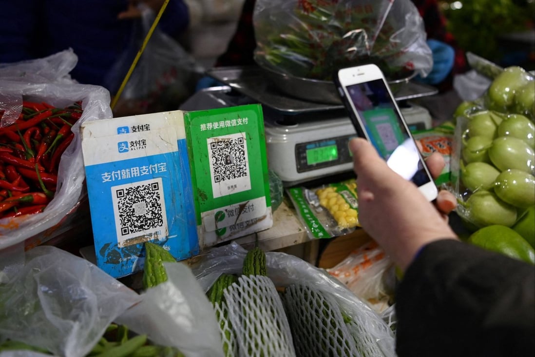 A shopper pays using a QR code at a vegetable market in Beijing. Photo: AFP