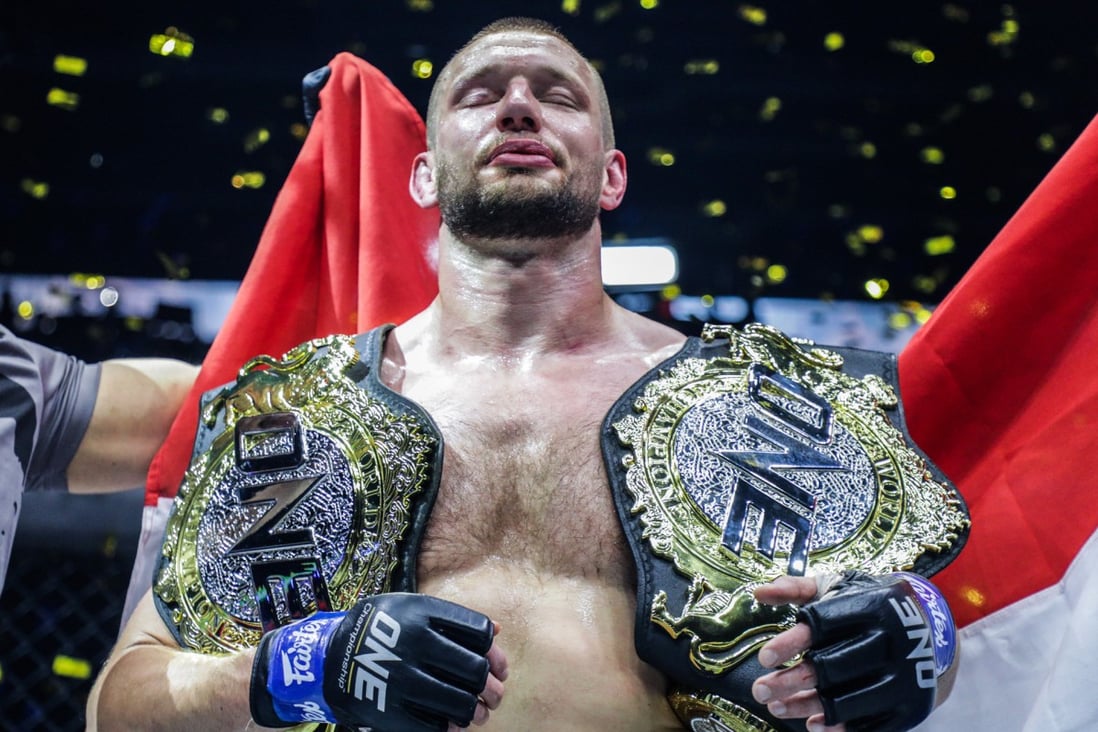 Reinier de Ridder celebrates with his two world titles. Photo: ONE Championship