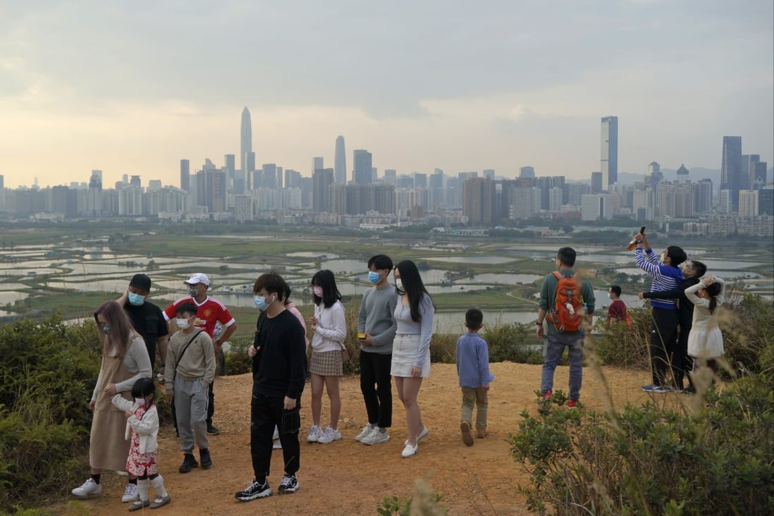 People in Hong Kong visit the border with Shenzhen, with the mainland city’s skyline in the background, on February 13 last year. With its proximity to Shenzhen, the Northern Metropolis would integrate Hong Kong with the mainland’s overall development, but its announcement seems premature. Photo: AP