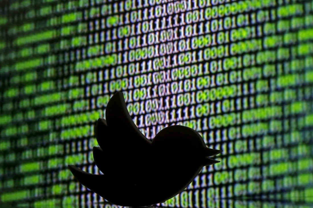 3D printed Twitter logo is seen in front of a displayed cyber code in this illustration taken March 2016. Photo: Reuters 
