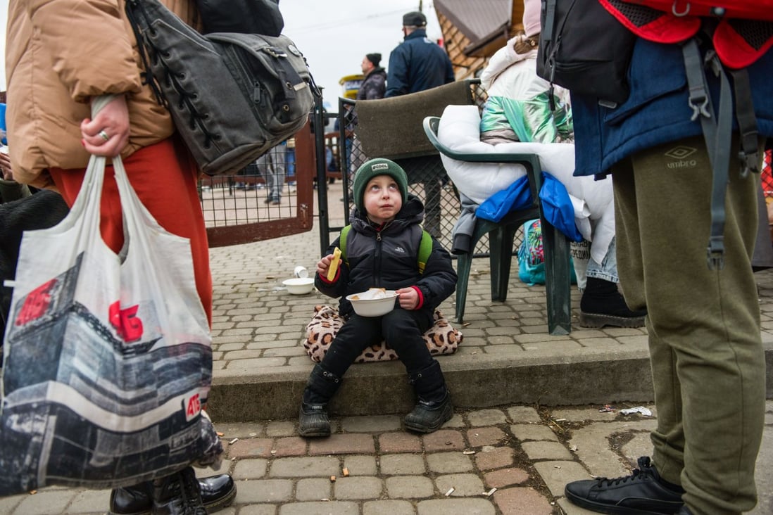 A refugee child eats at the food distribution point at the border crossing in Medyka, Poland on Friday. Photo: dpa