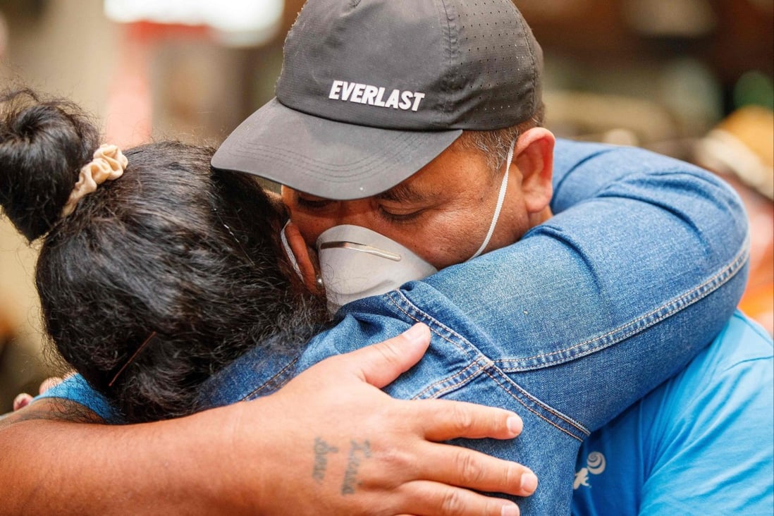 Loved ones reunite at Auckland airport on Monday, the first day of New Zealanders returning from Australia after the border reopened for travellers observing home self-isolation rules. Photo: AFP