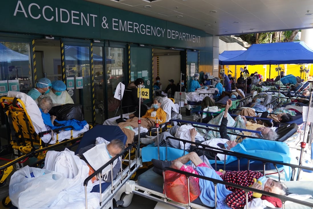 Patients with Covid-19 symptoms wait at a temporary holding area outside the Caritas Medical Centre in Hong Kong. The city has been hit by an escalating Covid-19 outbreak. Photo: Sam Tsang
