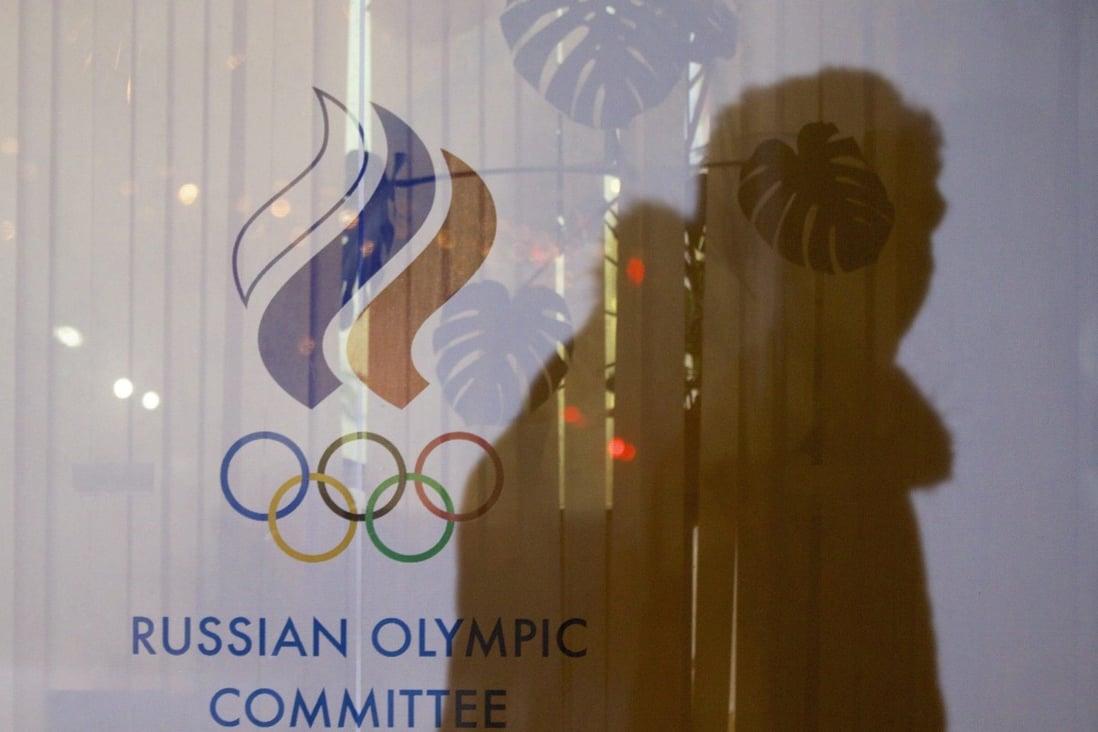 FILE - A man walking past the Russian Olympic Committee building casts a shadow on a window in Moscow. Photo: AP