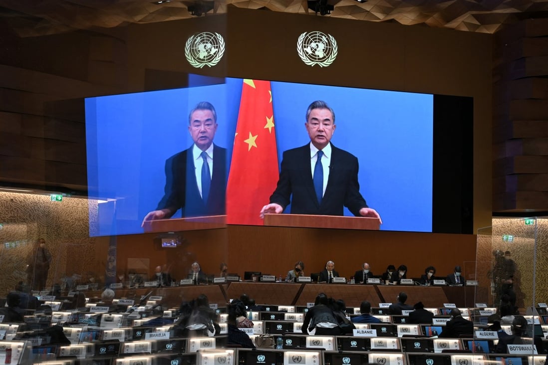 Chinese Foreign Minister Wang Yi appears on a screen as he delivers a speech at the opening of a session of the UN Human Rights Council in Geneva on Monday, following the Russian invasion in Ukraine. Photo: Reuters