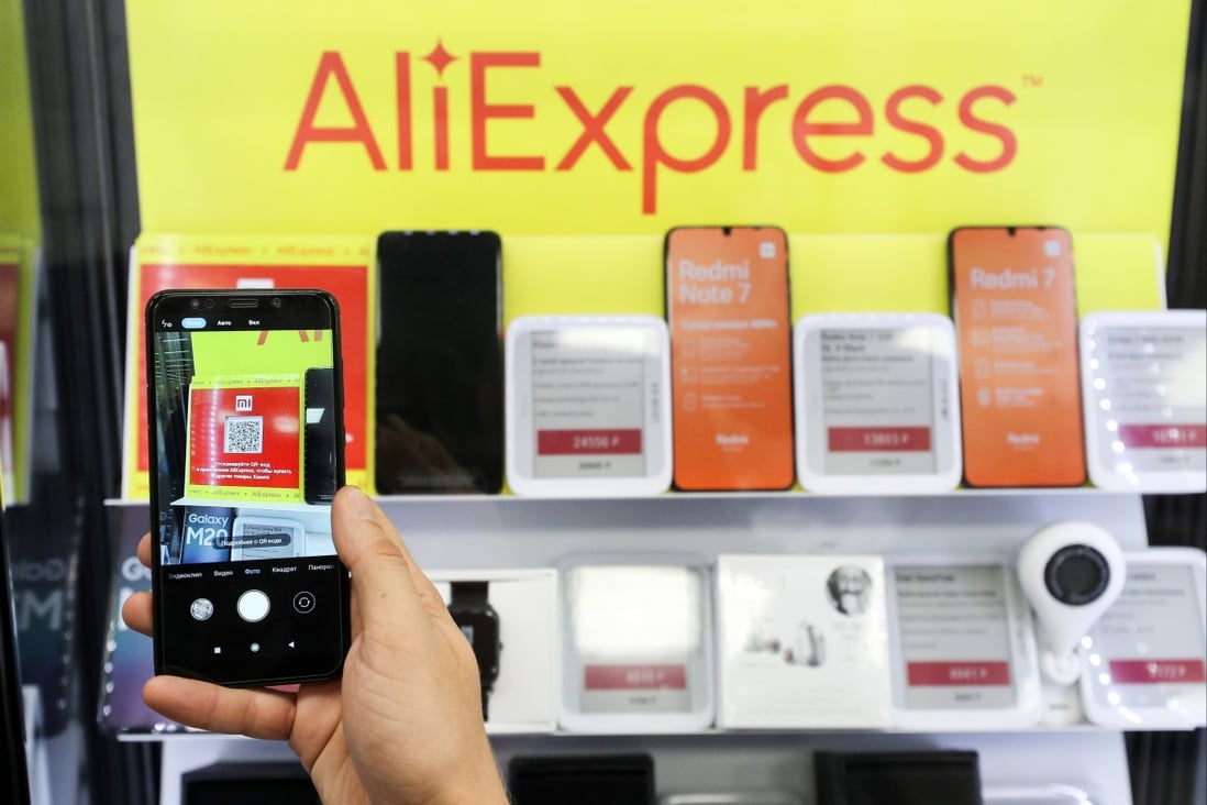 In this file photo dated August 8,  2019, an online retailer in Russia displays products in front of an AliExpress sign. Photo: Tass via Getty Images