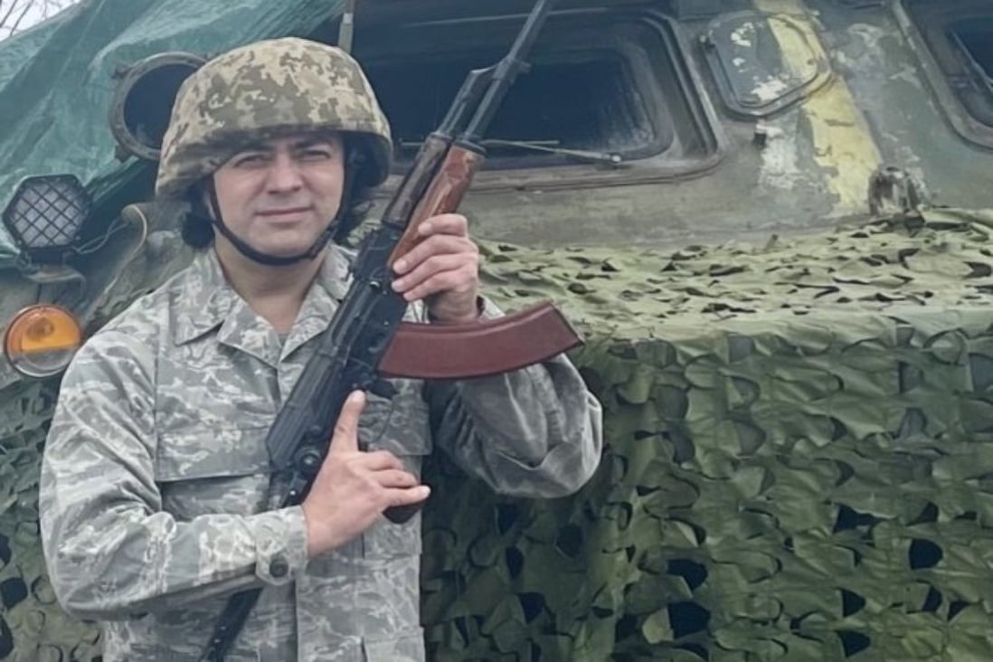 Contrabass player Ziuzkin Dmytro, 47, in front of a camouflaged military vehicle in Ukraine. He recently returned home from Seoul, where he was working as a member of the Seoul Pops Orchestra. Photo: Handout