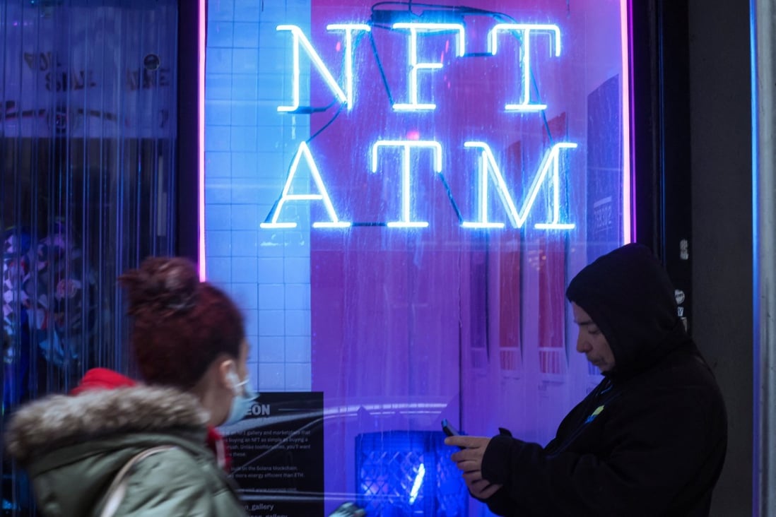 People pass a sign for an “NFT ATM” in a small storefront in Lower Manhattan’s financial district of New York on March 1, 2022.  Photo: Reuters