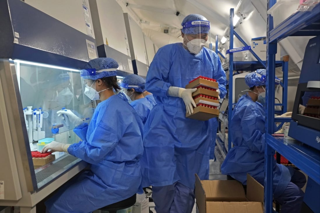 Health workers from mainland China test samples from Hong Kong residents for the coronavirus at an inflatable mobile testing lab in Hong Kong. Photo: AP