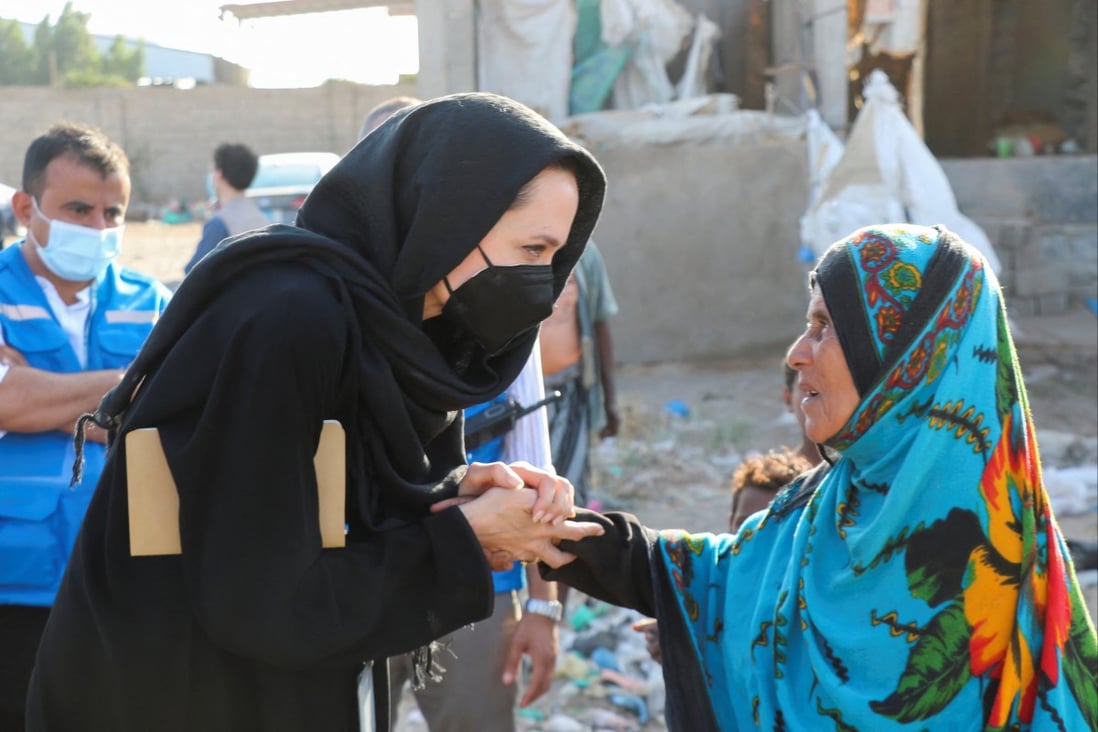 UNHCR special envoy Angelina Jolie shakes hands with a woman displaced by war during a visit to the southern province of Lahej, Yemen on March 6. Photo: Reuters