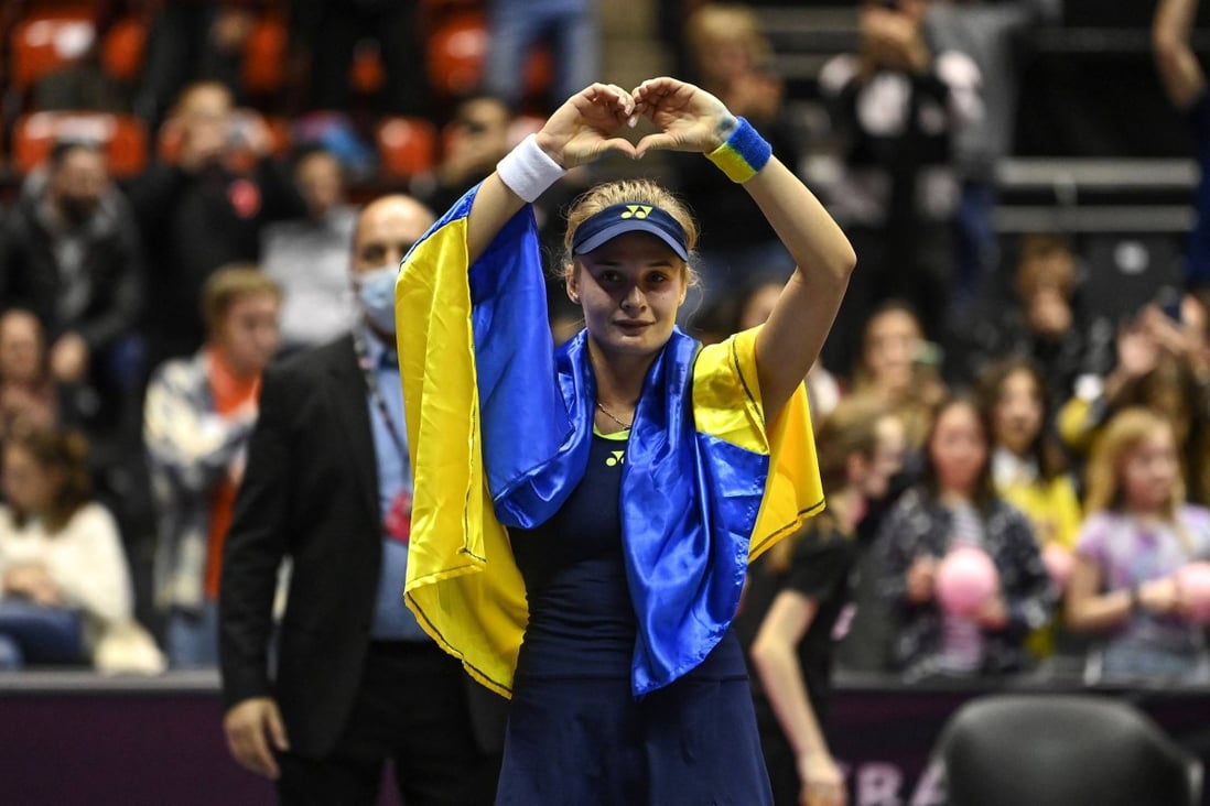 Ukraine’s Dayana Yastremska, wrapped in the Ukrainian national flag, reacts after the WTA 6eme Sens Open semi-finals in Lyon. Photo: AFP
