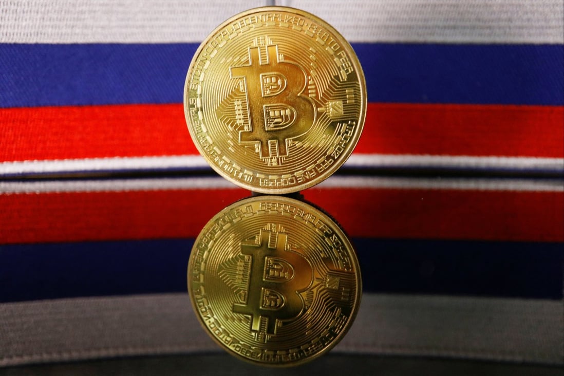A representation of bitcoin is displayed in front of Russian flags in this picture illustration taken March 4, 2022. Photo: Reuters