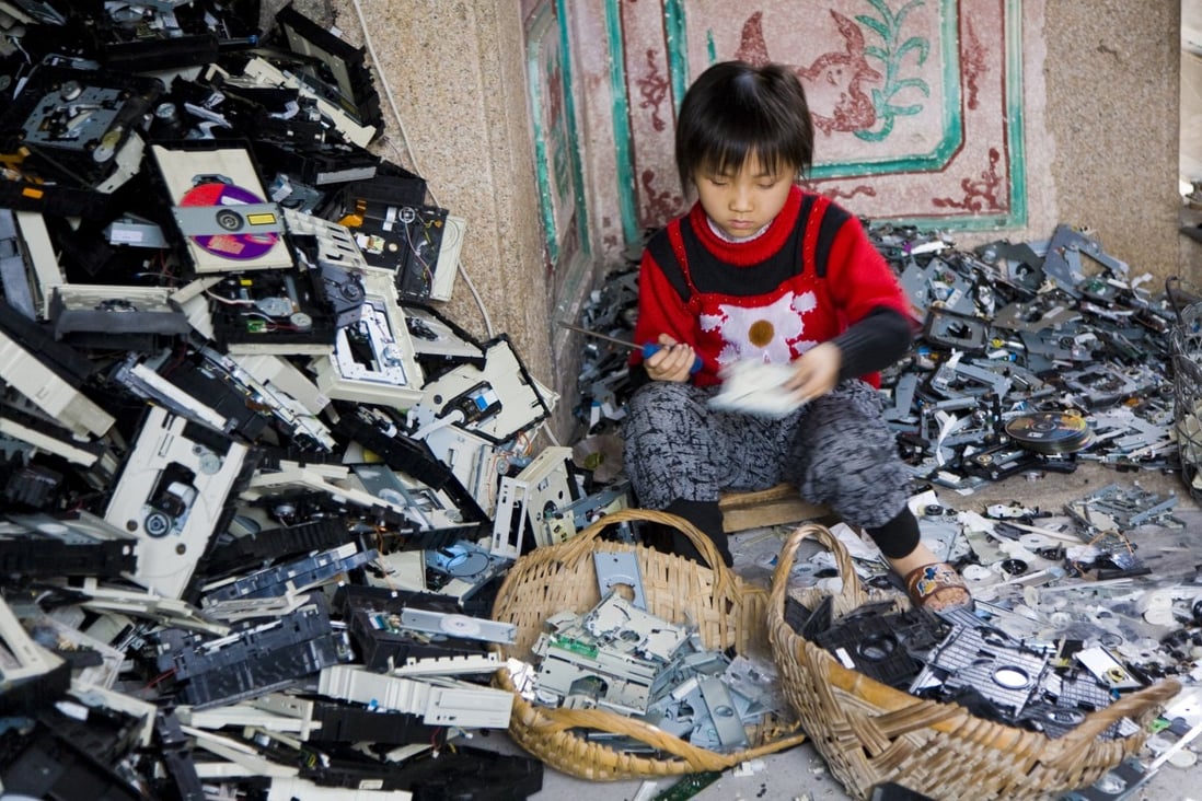 A young girl disassembles computer CD players in Guiyu, China. Bangladesh-born Mashiat Lamisa works with Projekt, a social enterprise that teaches Hong Kong people how to repair gadgets so they don’t end up as trash for poor children to disassemble, and to turn old ones into jewellery. Photo: Getty Images