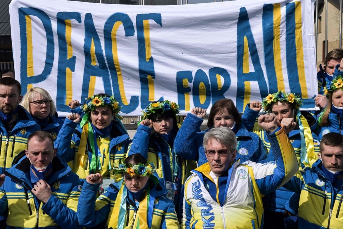 Ukraine’s delegation shows a banner reading ‘peace for all’ as they hold a moment of silence and speak to the media at the Beijing Winter Paralympic Games at the Zhangjiakou Athletes’ Village. Photo: AFP   