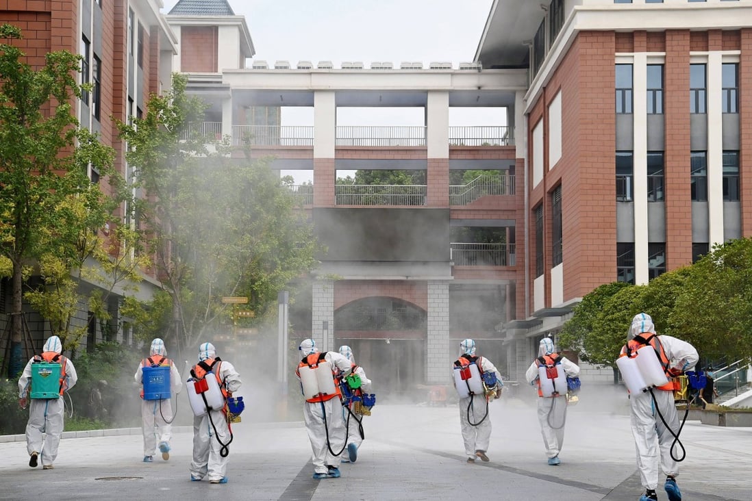 Workers disinfect the compound of a primary school in Wuhan, China’s Hubei province. File photo: Reuters