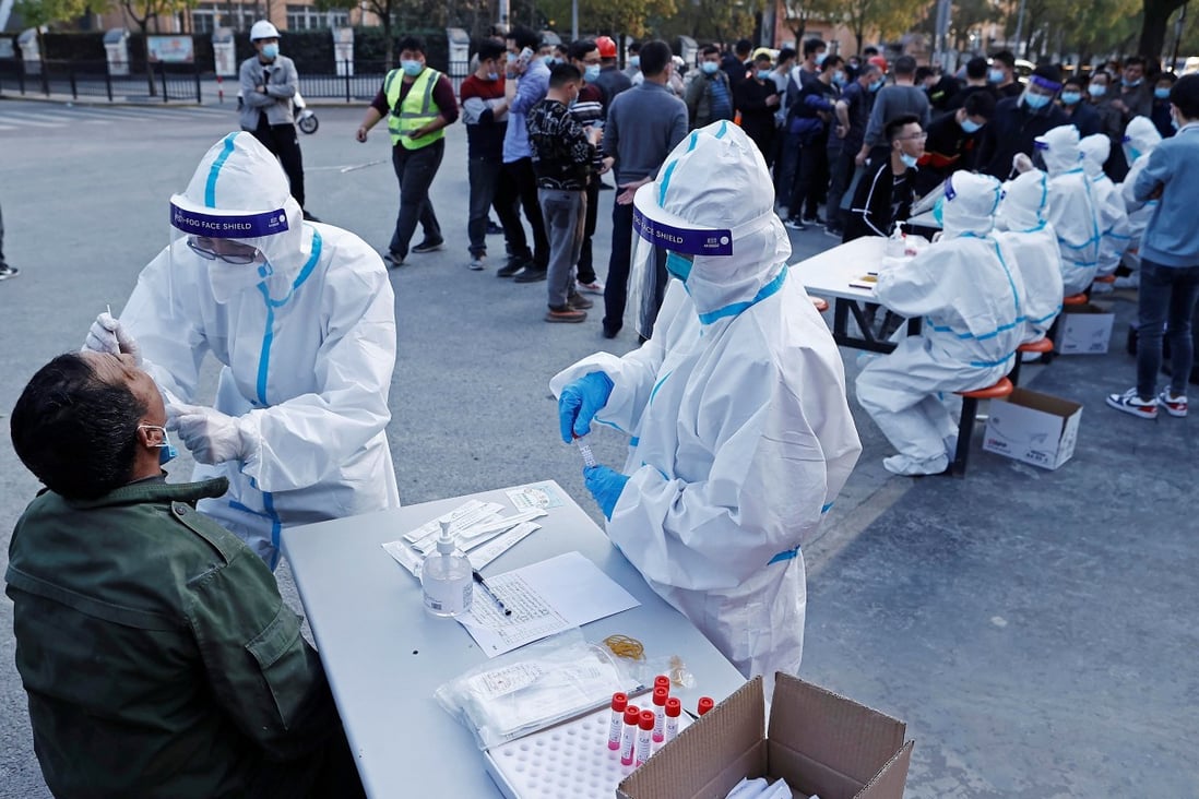 Medical workers collect swabs from residents at a makeshift testing site in Shanghai. Photo: Reuters