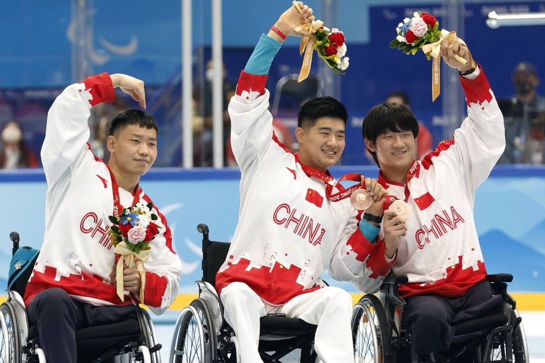 Members of China’s para ice hockey team celebrate with their bronze medals. Photo: Reuters