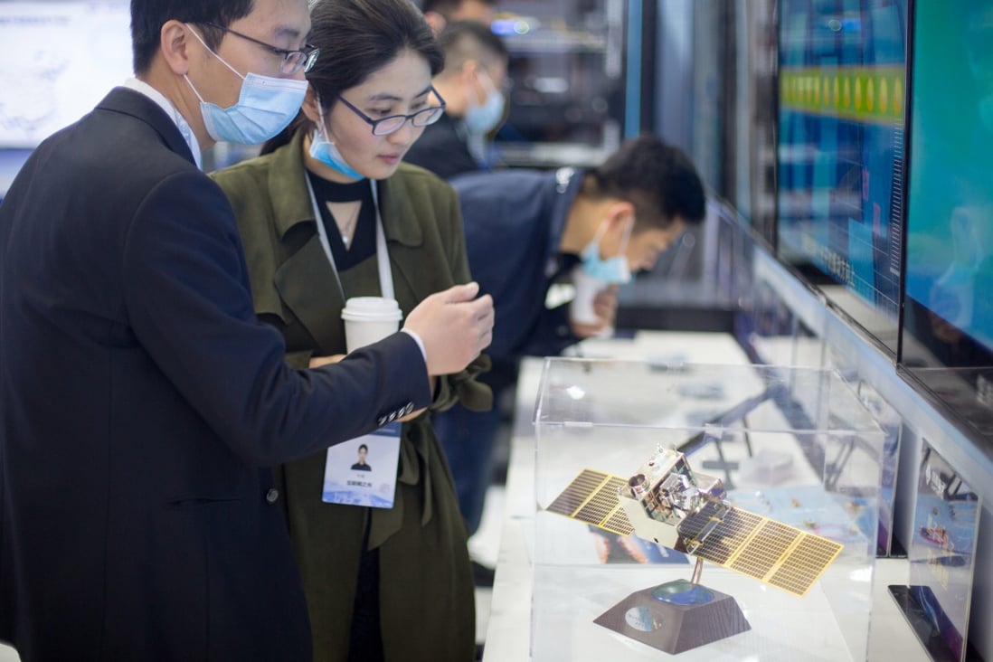 Visitors look at a model of the quantum communication satellite Mozi in Wuzhen, Zhejiang province, in November 2020. Photo: Costfoto/Barcroft Media via Getty Images