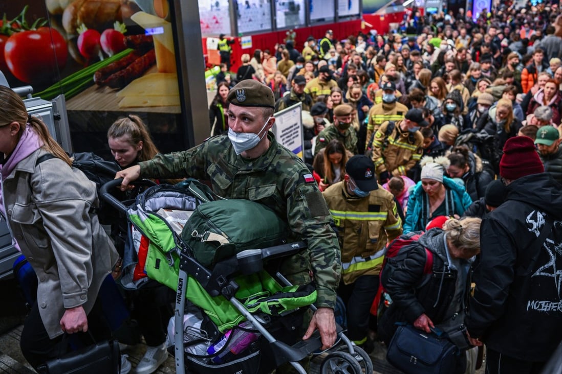 People fleeing the war in Ukraine walk towards a train which will take them to Berlin from Karkow, Poland, on March 15. Of the roughly 3 million refugees forced to leave Ukraine, more than half have crossed into neighbouring Poland. Photo: TNS