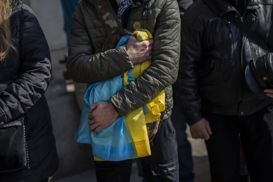 People attend a funeral ceremony on Tuesday for four Ukrainian servicemen who were killed during an airstrike on a military base in Yarokiv. Photo: AP