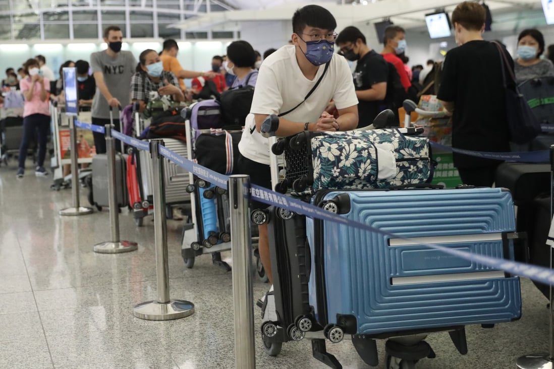 Passengers wait at check-in counters at Hong Kong International Airport on June 29, 2021. Photo: Edmond So