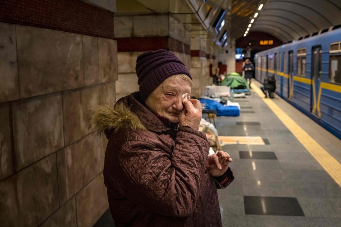 A woman weeps in a metro station being used as bomb shelter in Kyiv. Photo: AFP