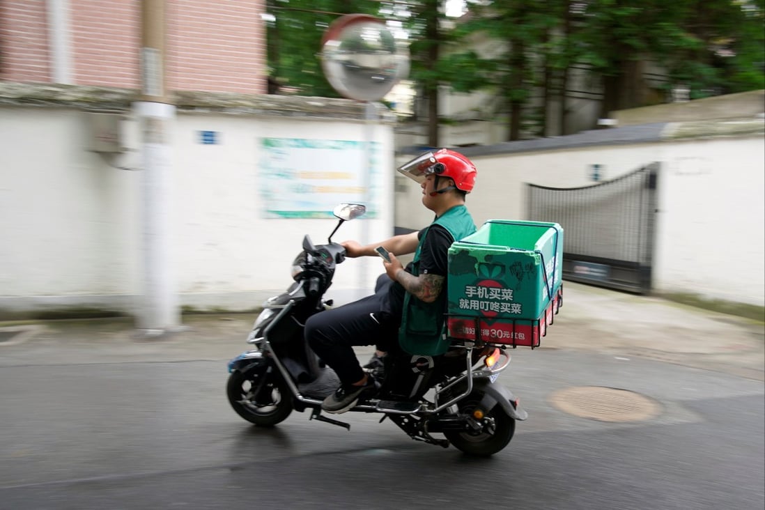 A delivery worker of Chinese online grocery Dingdong Maicai, in Shanghai in June. Photo: REUTERS
