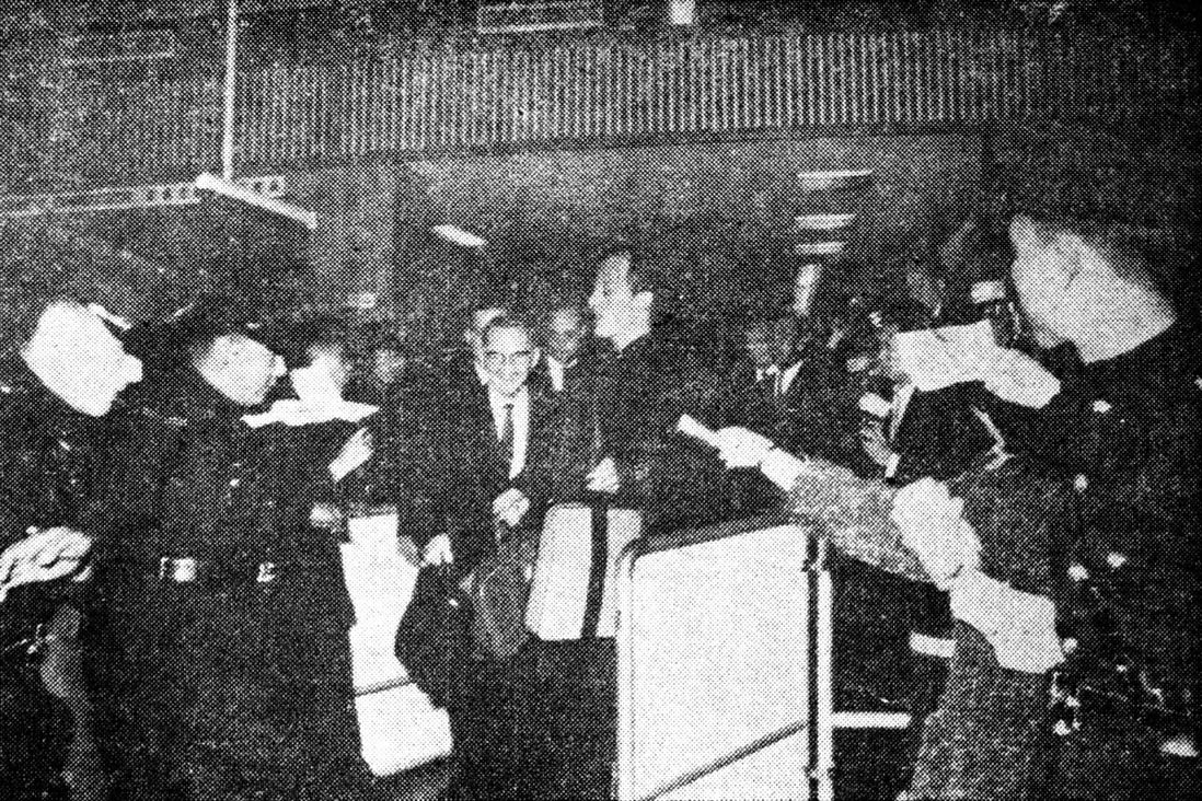 Crowds of excited fans follow Pat Boone (centre) as he exits the customs enclosure at the Kai Tak Airport in March,1964. The singer performed two concerts at City Hall.