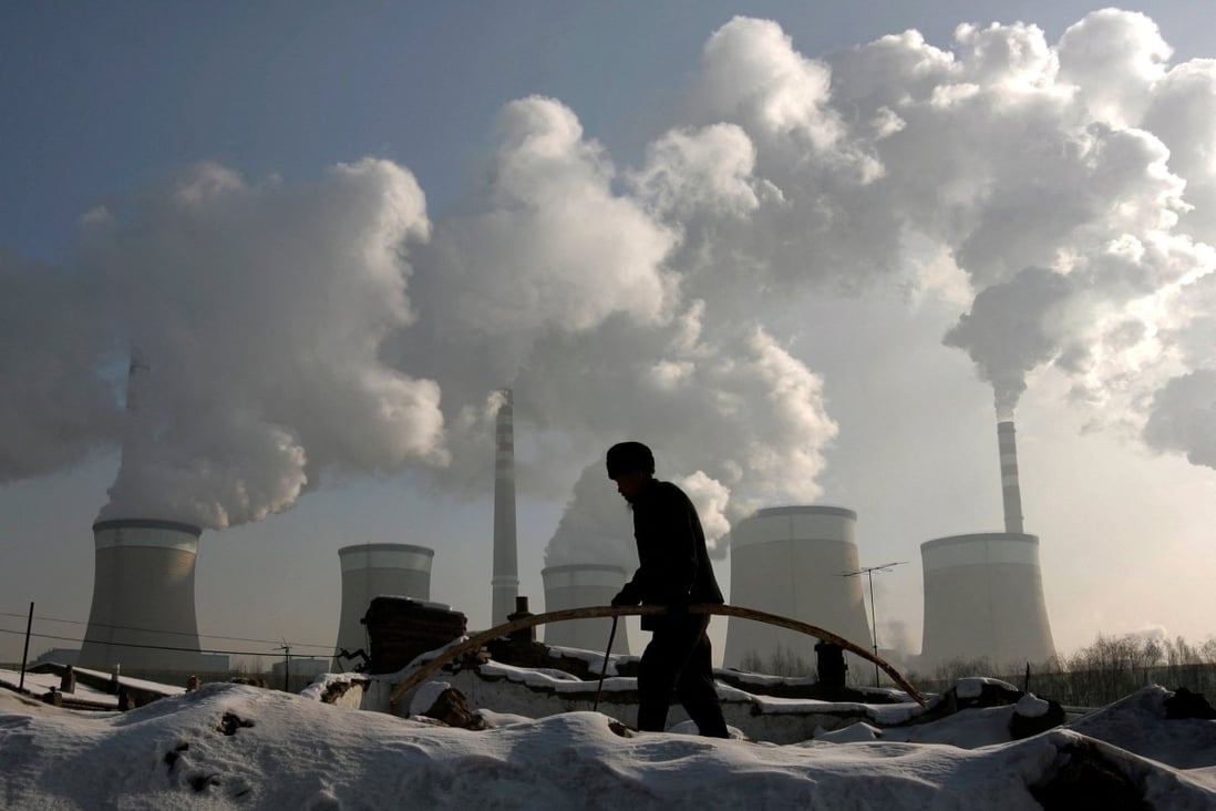 A villager walks past a coal-fired power plant in Shanxi province, one of the more developed fossil fuel regions. Photo: Reuters