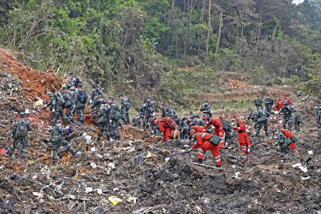 Rescue workers search the site in Guangxi where the plane crashed with 132 people on board. Photo: AP