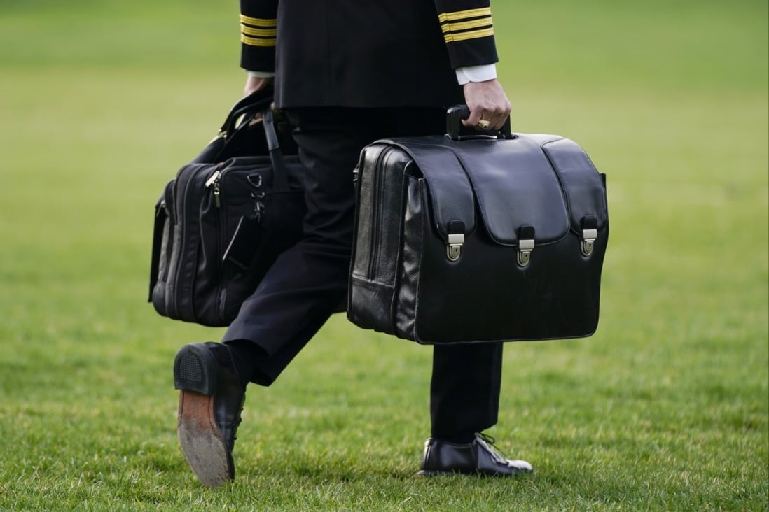 A US military aide carries the ‘President’s emergency satchel’, also known as ‘the football,’ which contains nuclear launch codes, before boarding Marine One behind President Joe Biden. Photo: AP