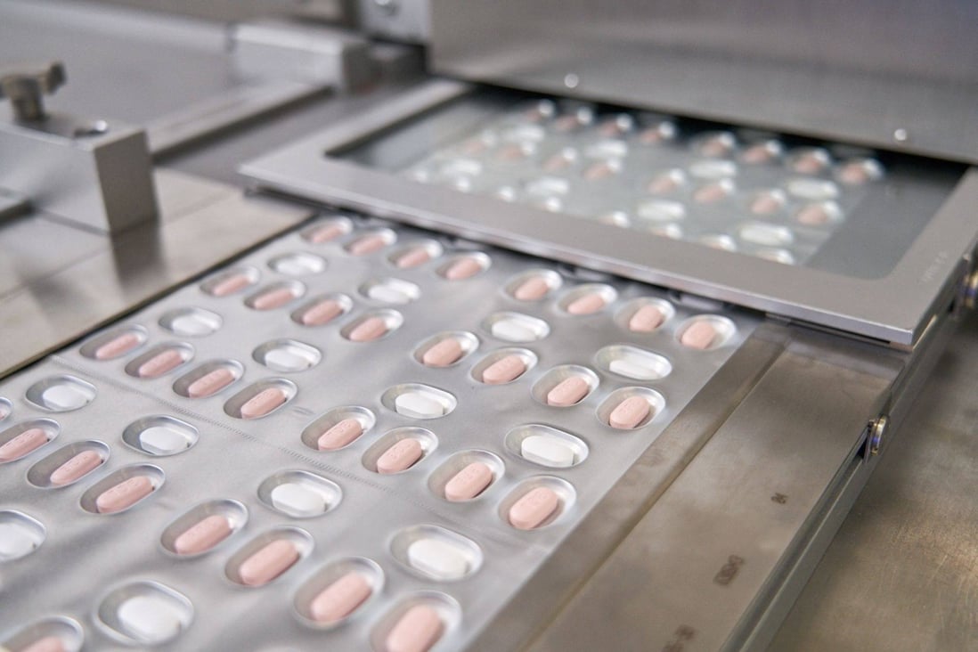 Courses of Pfizer’s anti-Covid drug Paxlovid roll off of a production line in Germany. Photo: AFP