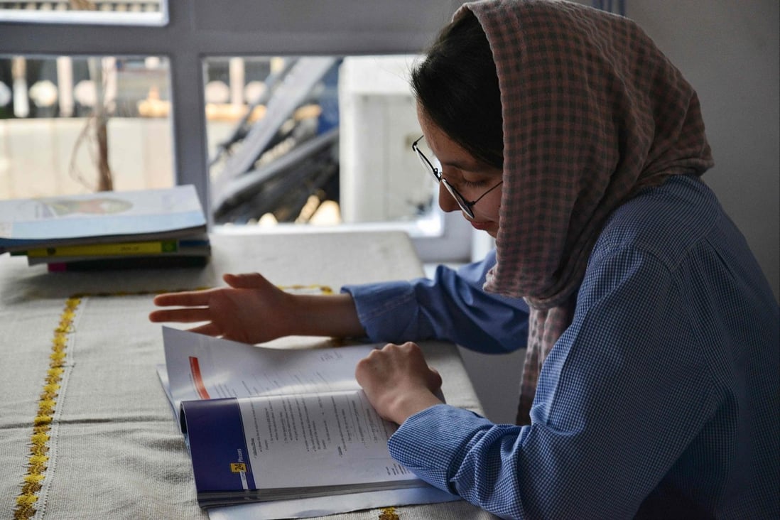 Nargis Jaffari studies at home in Kabul days after Taliban’s U-turn on allowing Afghan girls back to school. Photo: AFP