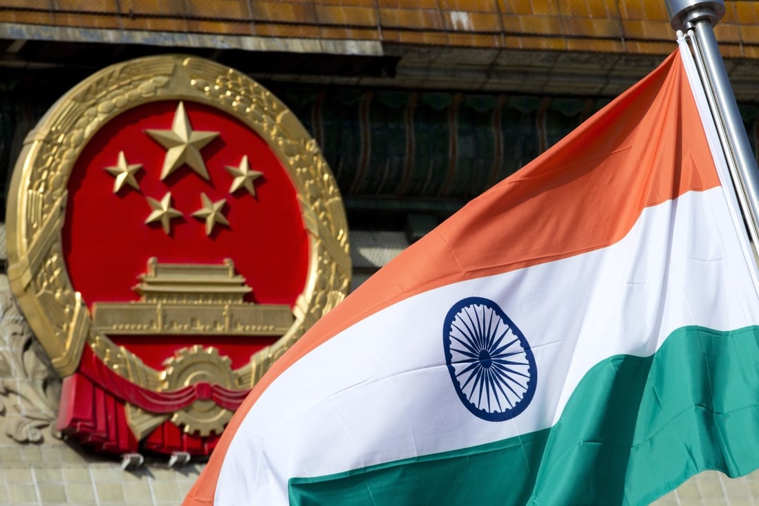 An Indian national flag is flown next to the Chinese national emblem in Beijing. Photo: AP