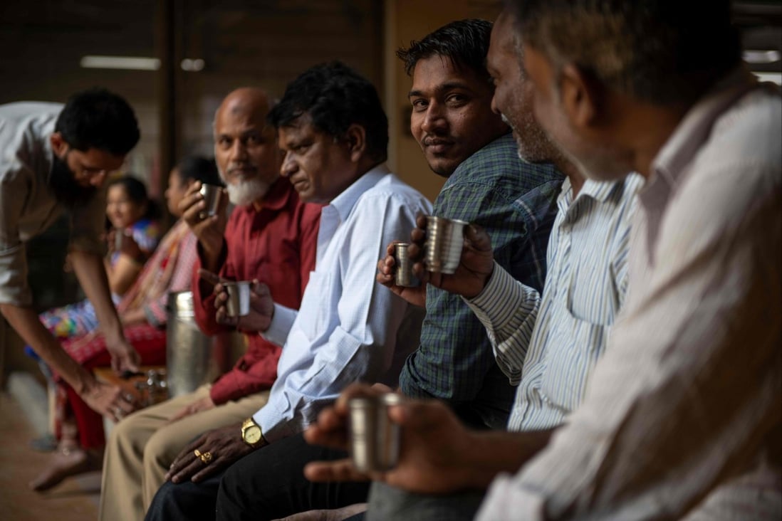 Men drink tea during a break at a factory in Mumbai. Tea is an ever-present part of Indian culture. Photo: AFP