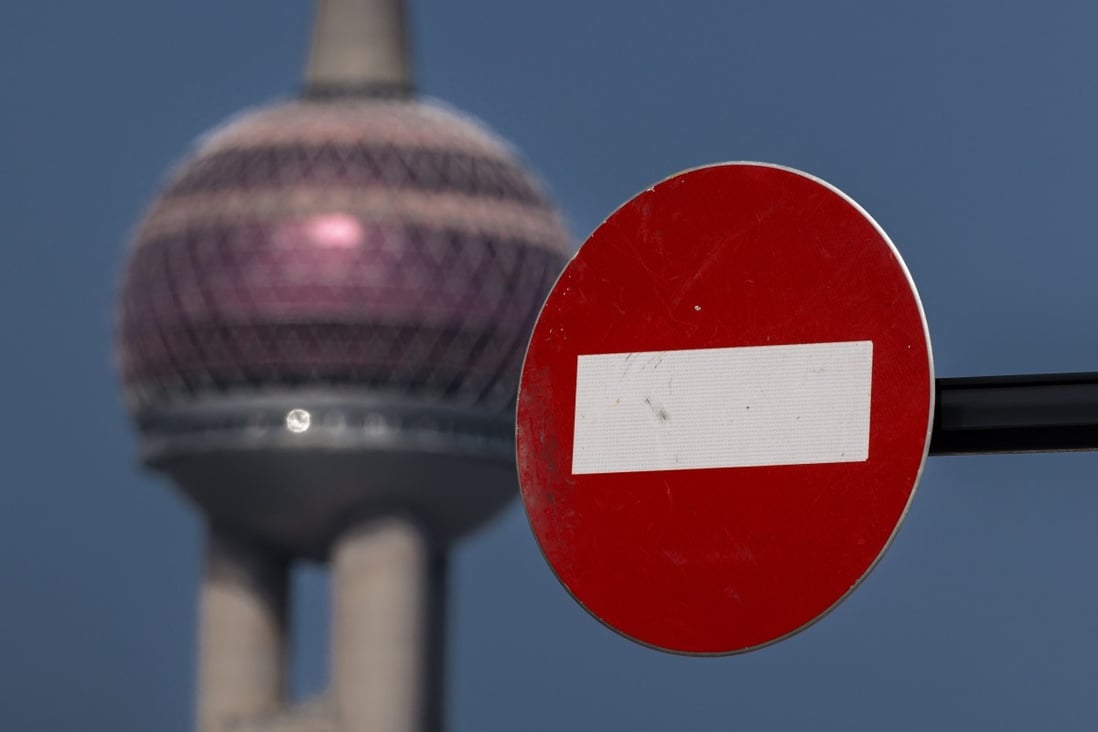 A ‘no entry’ sign stands on the street while the Pearl of the Orient Tower, one of Shanghai’s most famous landmarks, stands in the background in Pudong, which is under lockdown, is seen in the background on 29 March 2022. Photo: EPA-EFE