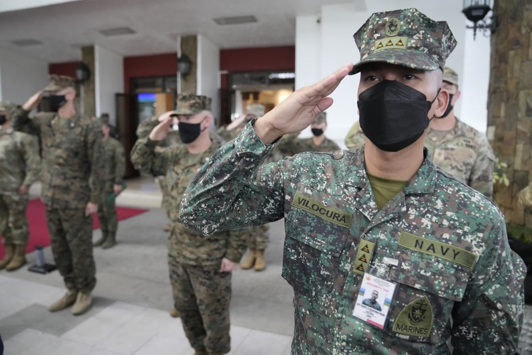 Philippine and US soldiers salute during the opening ceremony of the Balikatan drills on March 28, 2022. Photo: AP