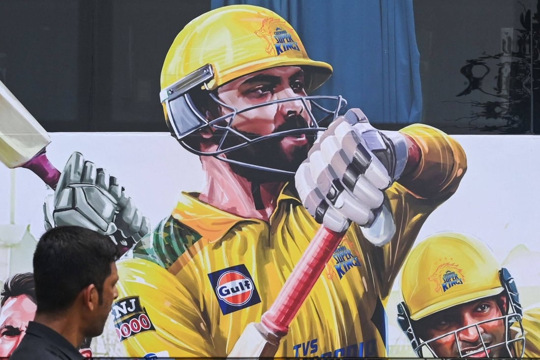 A pedestrian walks past an image depicting Indian cricketer Ravindra Jadeja, who will captain the Chennai Super Kings in this season’s IPL. Photo: AFP