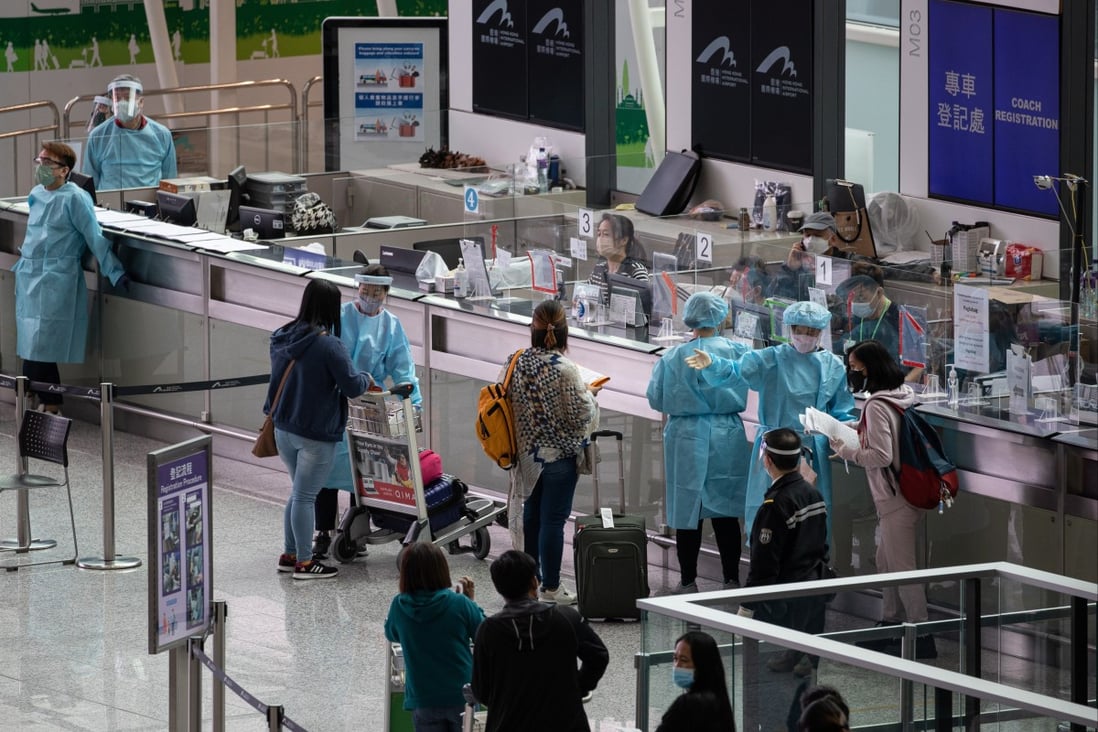Passengers landing at Hong Kong International Airport wait to be transported to quarantine hotels. The amendments to rules for travellers and airlines have been welcomed in Hong Kong, but have also caused some uncertainty as flights may still be suspended and arrivals made to quarantine beyond the new seven-day requirement if they test positive for Covid-19. Photo: EPA-EFE