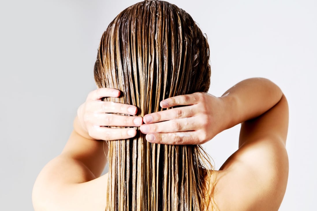 A woman applies a hair mask. Used after shampooing, they should be kept on your hair for a few minutes. They offer people with dry or damaged hair a temporary fix but are not for daily use, experts say. Photo: Shutterstock 