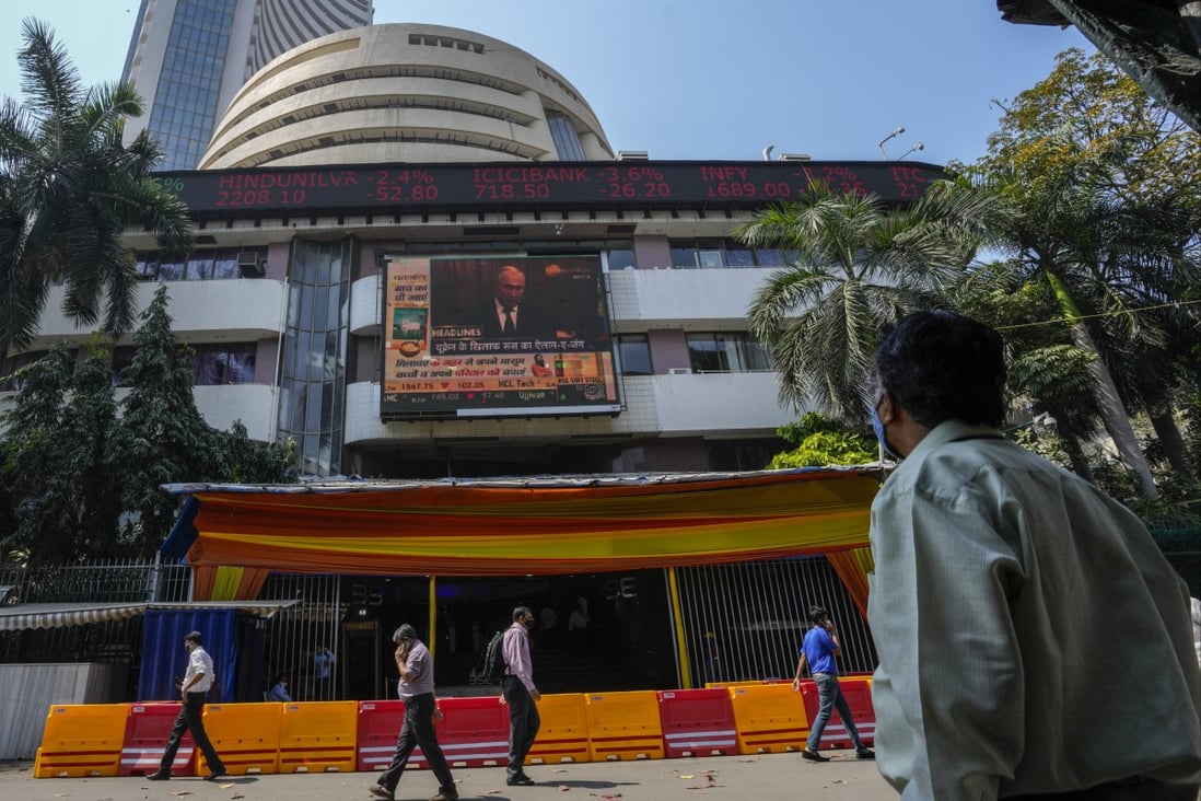 A screen showing the news featuring Russian President Vladimir Putin on the facade of the Bombay Stock Exchange building in Mumbai, India. Photo: AP