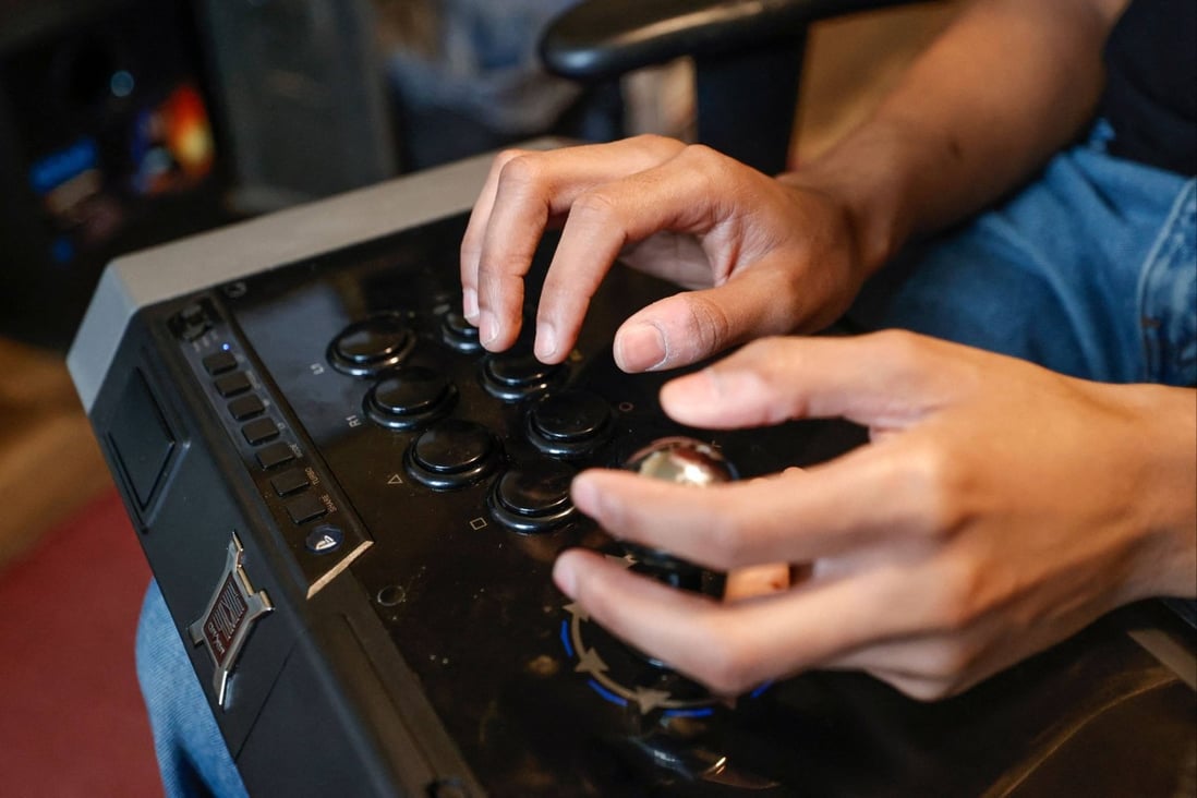 Deaf gamer Chris Robinson plays a video game in his apartment on March 26, 2022. More game makers are keeping accessibility in mind when designing software, adding settings intended to level the field for players with disabilities. Photo: AFP