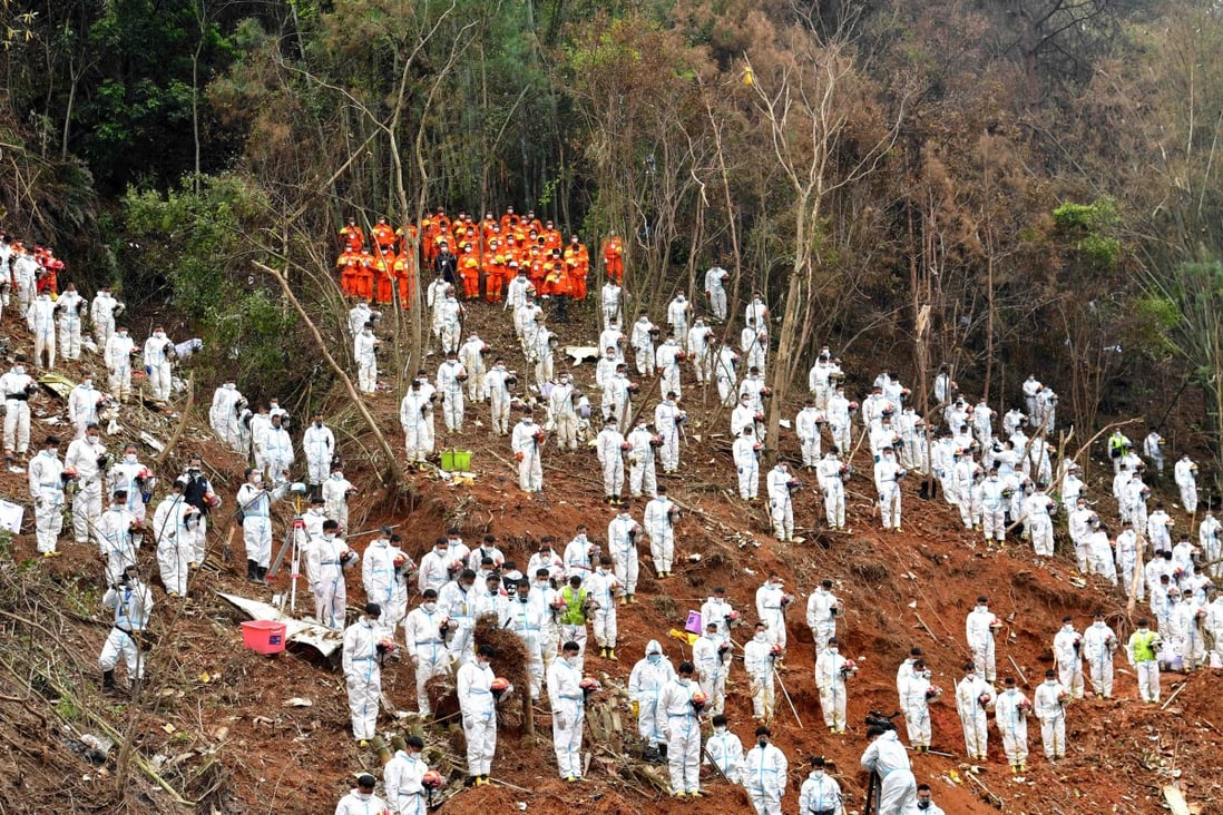 Emergency response and rescue workers pause on March 27 during a memorial ceremony for the victims of Flight MU5735. The head of China’s Civil Aviation Administration has said he will reflect on the disaster and step up safety vigilance. Photo: Xinhua
