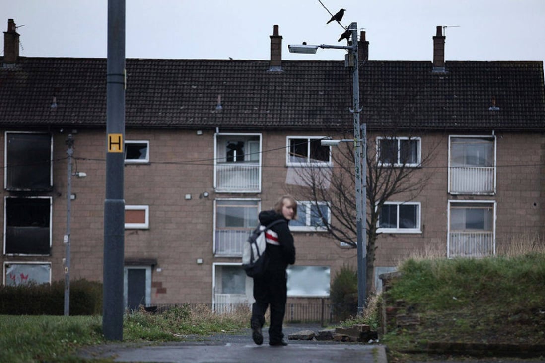 A young boy makes his way home from school on a public housing estate in Glasgow, Scotland, the setting for Douglas Stuart’s new novel, Young Mungo. Photo: Getty Images