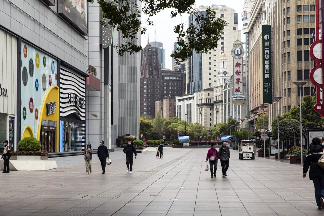 Pedestrians along the near-empty Nanjing Road shopping street outside of the impacted areas during a lockdown in Shanghai on March 31. Photo: Bloomberg