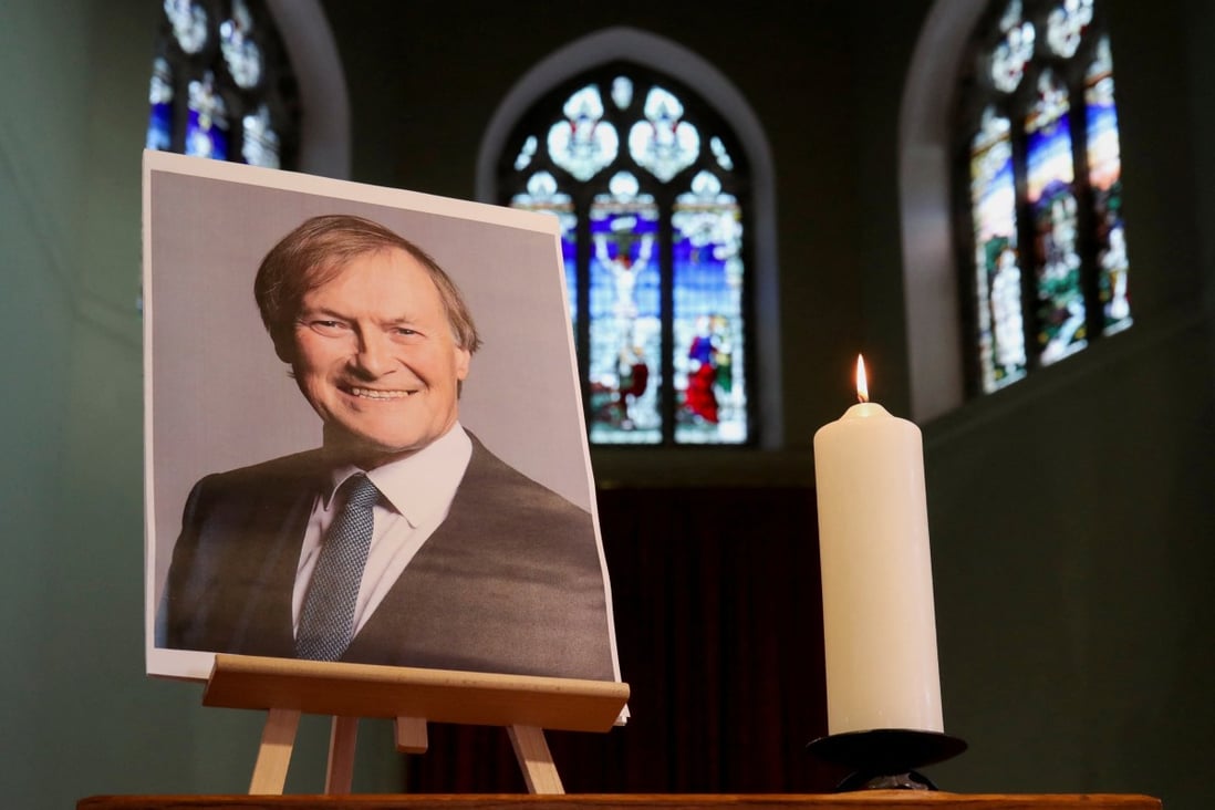 A candle and a portrait of British MP David Amess, who was stabbed to death during a meeting with constituents, are seen at a church in Leigh-on-Sea in October. Photo: Reuters