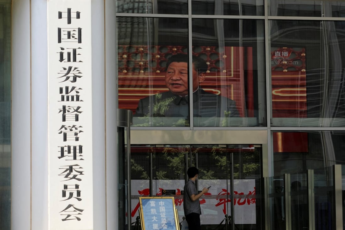 A screen shows news footage of Chinese President Xi Jinping at the China Securities Regulatory Commission building in Beijing. Photo: Reuters